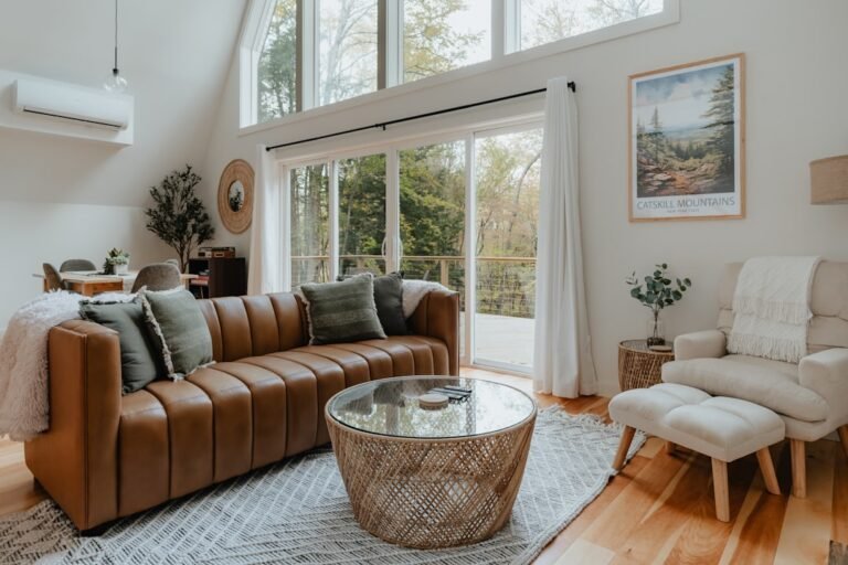 Brown leather sofa in a living room for the HODEALS leather sofa cleaning guide. Photo by Clay Banks on Unsplash.